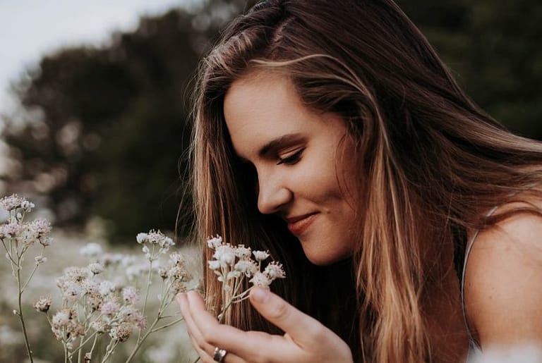 girl-enjoying-flowers-fragrance